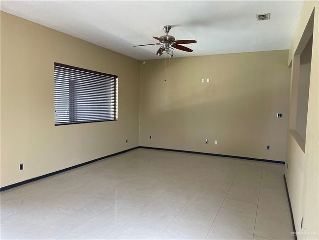 Empty room with a ceiling fan and baseboards | Image 30