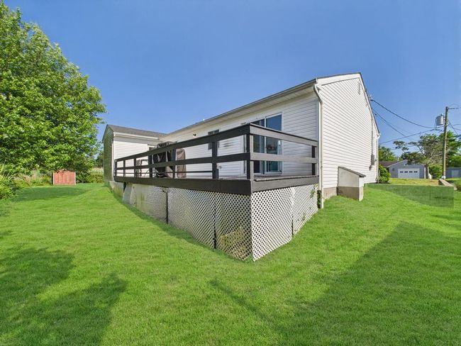 Back of property featuring a yard and a wooden deck | Image 34