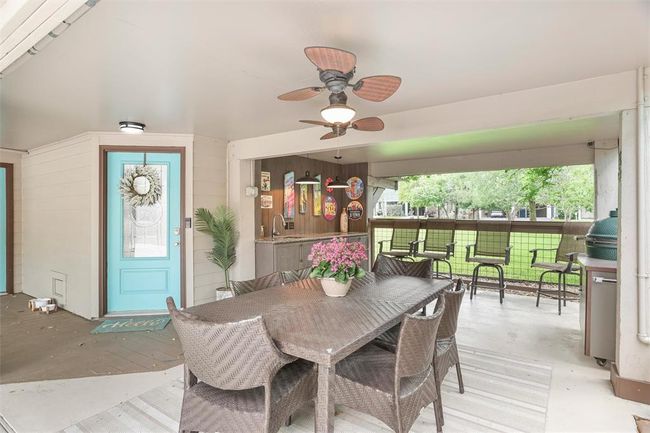 Covered area off the entryway fabulous for dinning outdoors, equipped with a sink. | Image 9