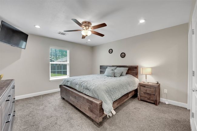 Bedroom featuring light carpet, recessed lighting, visible vents, and baseboards | Image 21