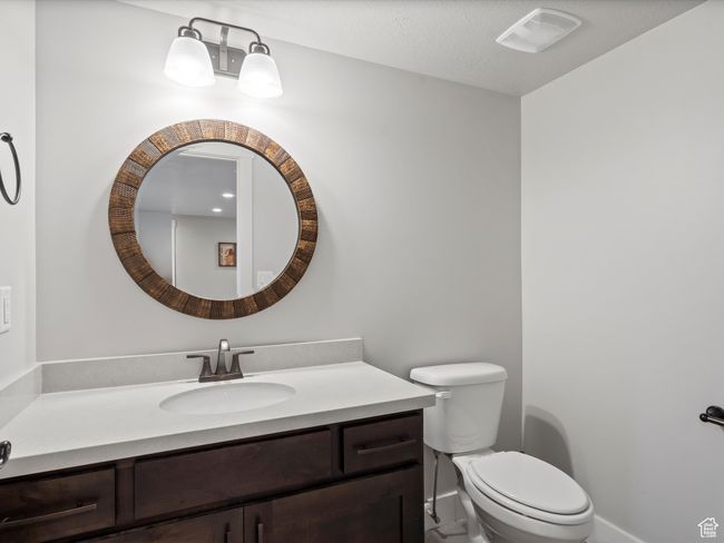 Bathroom featuring vanity, toilet, and baseboards | Image 38