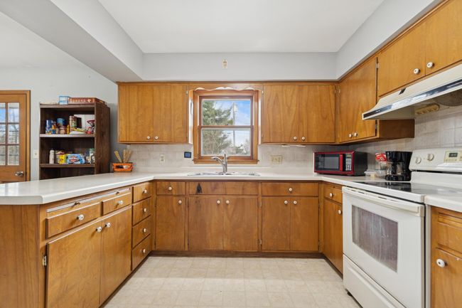 The kitchen window overlooks the beautiful back yard! | Image 5
