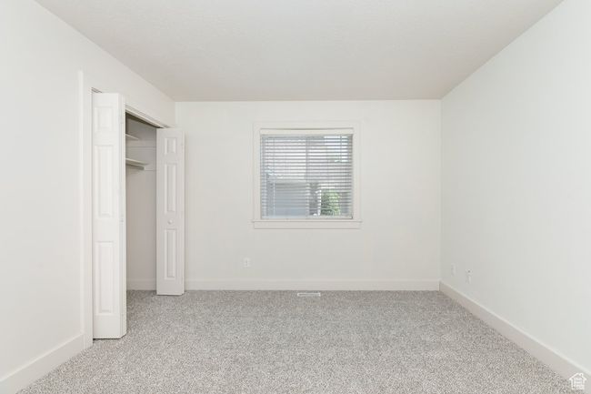 Unfurnished bedroom featuring light colored carpet | Image 18