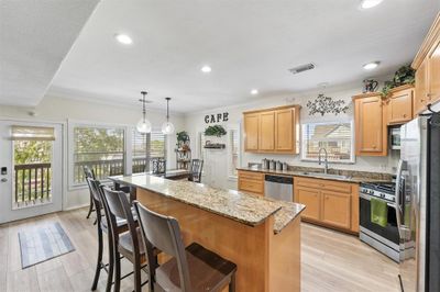 Open kitchen area with island bar | Image 3