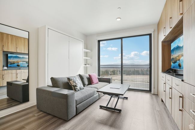 Living area featuring light wood-style floors | Image 6