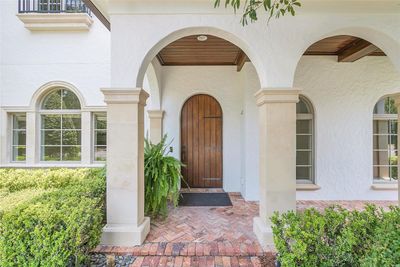 Welcoming entry with brick and stone pillars and natural wood details | Image 2