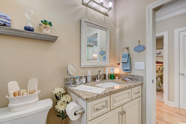 Bathroom featuring shower / bath combination with curtain, toilet, vanity, and tile patterned floors | Image 30