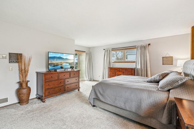 Large upper level owners suite with private walk-out access to the deck | Image 23