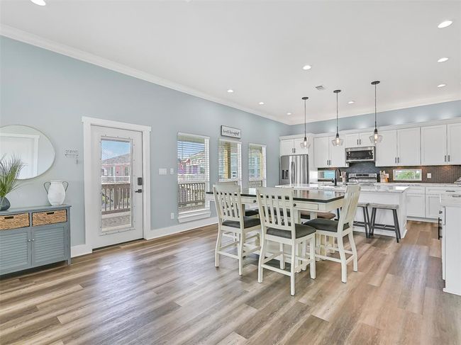 Abundant natural light fills the dining and kitchen area, enhanced by energy-efficient double-paned storm windows and spray foam insulation—designed for year-round comfort and reduced utility costs. | Image 12