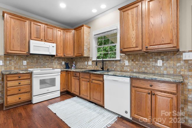 Through the entry is the kitchen and main living area | Image 7