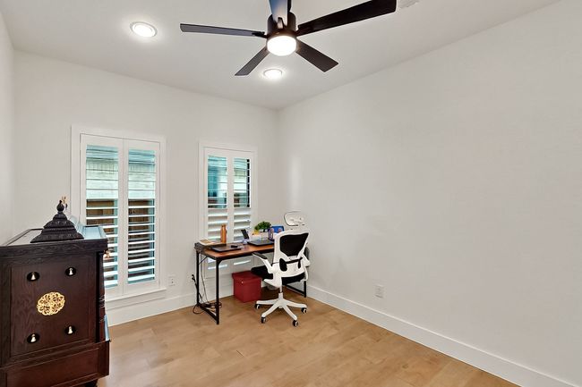 Office featuring light wood-type flooring, baseboards, and ceiling fan | Image 33
