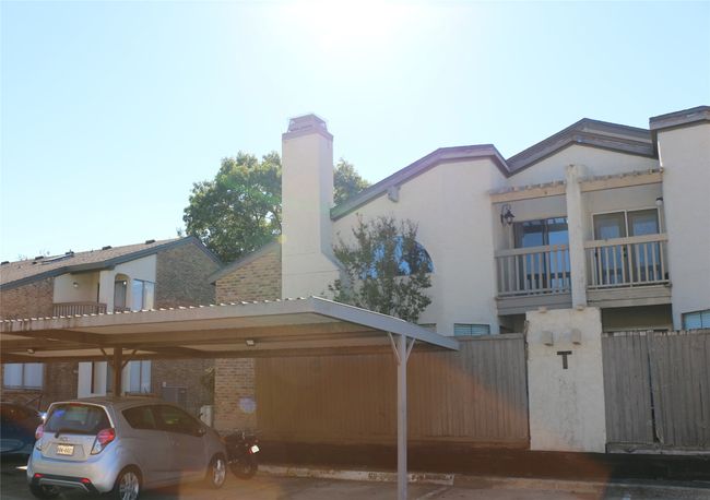 View of side of home with covered parking and a chimney | Image 6