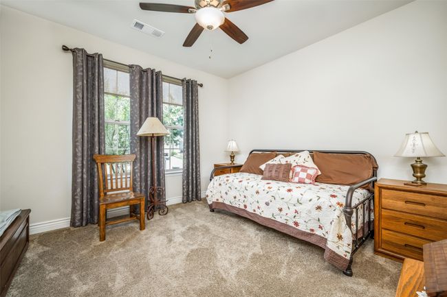 Bedroom featuring ensuite, carpet floors, a ceiling fan, and lofted ceiling | Image 5