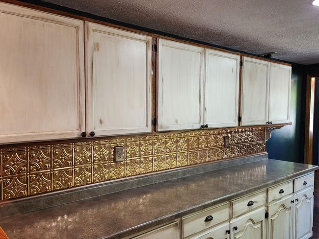 The high resolution countertops and tin-type backsplash add character. | Image 7