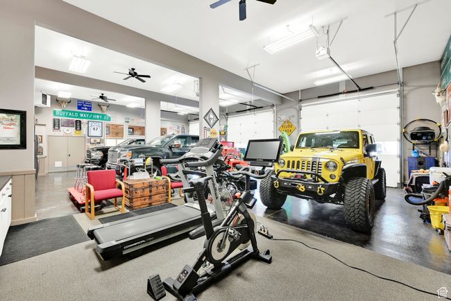Interior space featuring a garage door opener and ceiling fan | Image 53