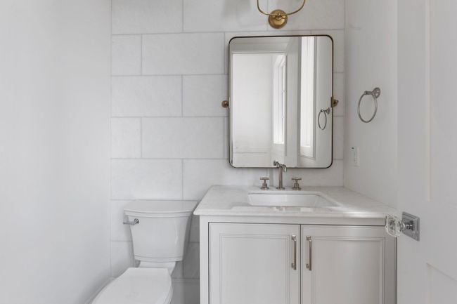 Tucked away on a private landing down the staircase, the second floor half bath features gorgeous finishings and privacy. | Image 19