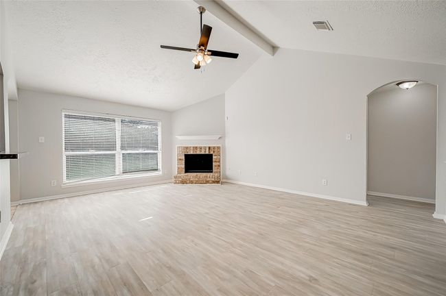 Spacious living room area with luxury vinyl and a fireplace | Image 6
