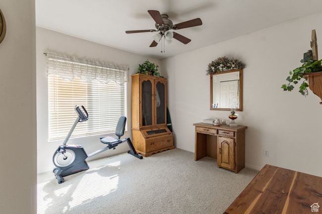 Workout room with a ceiling fan and light carpet | Image 19