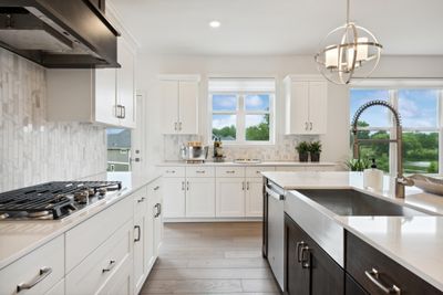 (Photo of model home, finishes will vary) For home chefs of all skills levels, this gourmet kitchen showcases an inviting center island, extensive cabinetry for abundant storage space and high-end double wall ovens to craft feasts of all sizes. | Image 2