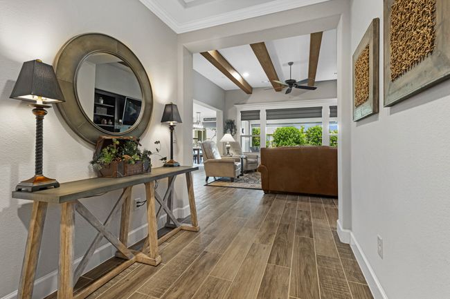 Hallway featuring beamed ceiling, wood finished floors, baseboards, crown molding, and recessed lighting | Image 4