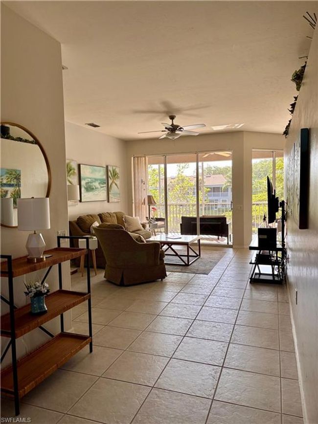 Spacious living room with a triple slider to the lanai. | Image 8