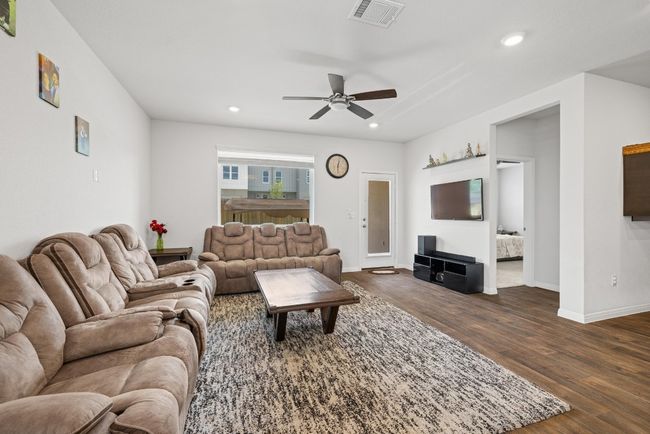 Living area with ceiling fan, dark wood-style floors, recessed lighting, and baseboards | Image 7