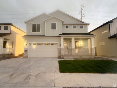 View of front of home featuring covered porch and a garage | Image 1