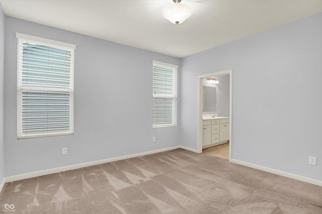 spare room featuring light carpet and baseboards | Image 11