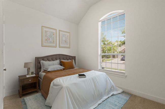 Bedroom with lofted ceiling and carpet floors | Image 10