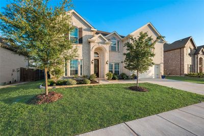 View of front facade featuring a front yard and a garage | Image 2