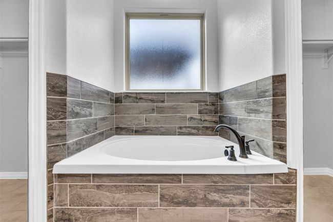 Bathroom with tile patterned flooring and tiled bath | Image 20