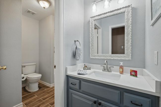Bathroom with wood tiled floors, toilet, vanity, and baseboards | Image 24