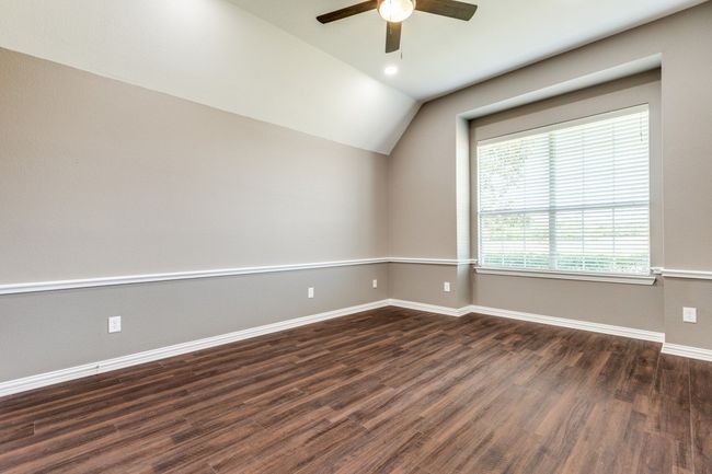 Bedroom with lofted ceiling, a ceiling fan and baseboards | Image 25