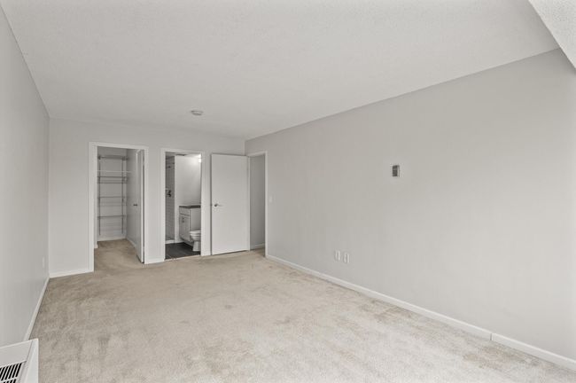 Another look at the primary bedroom, with walk-in closet and private 3/4 bath | Image 17