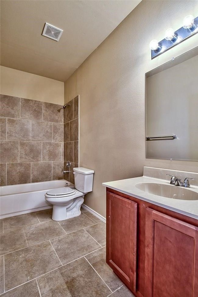Full bath with vanity, shower / washtub combination, and tile patterned flooring | Image 13