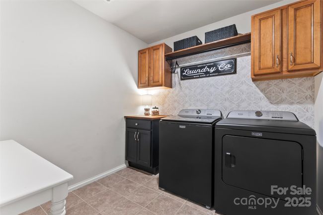 Laundry room with tons of storage and statement wall | Image 29