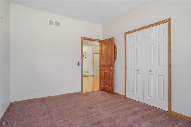 Unfurnished bedroom featuring baseboards, visible vents, carpet floors, and a closet | Image 35