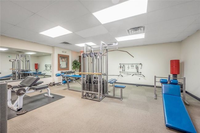Workout area featuring a drop ceiling and carpet | Image 15