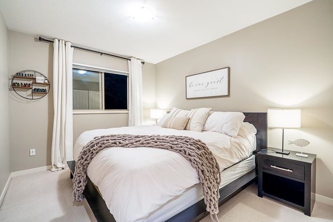 Bedroom featuring light colored carpet and baseboards | Image 24