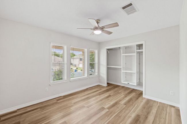 Unfurnished bedroom featuring light wood-style floors, a closet, baseboards, and a ceiling fan | Image 26