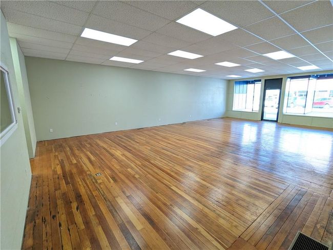Unfurnished room with a paneled ceiling and wood-type flooring | Image 12