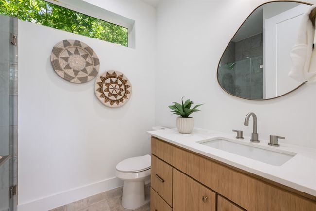 Full bath with a shower with shower door, toilet, vanity, and baseboards | Image 24