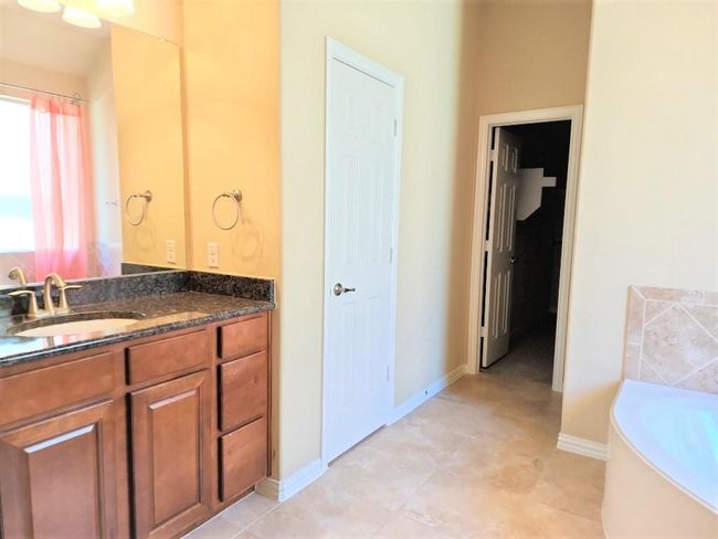 Full bath featuring vanity, a bath, and baseboards | Image 18