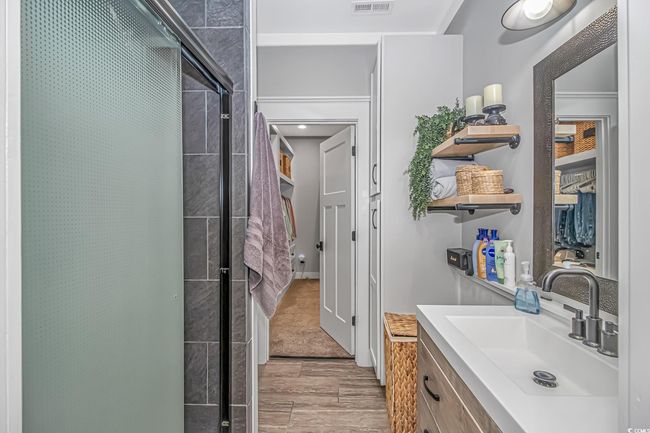 Bathroom with a shower stall, vanity, and wood finish floors | Image 20