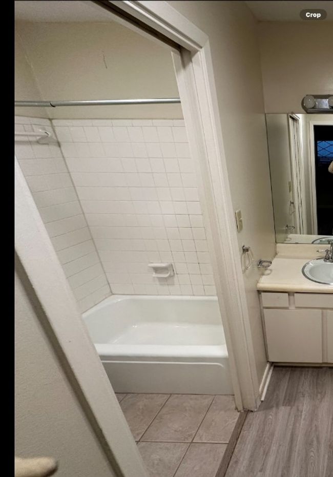 Bathroom with bathtub / shower combination, vanity, and wood finished floors | Image 26