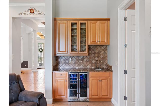 Lovely wet bar with refrigerator. | Image 21