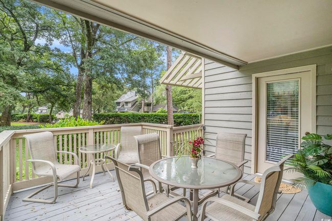 Private deck overlooking lush green lawn and shade trees. Quiet and peaceful with access from both living area and the primary bedroom! | Image 19
