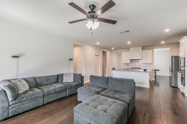 Living area featuring visible vents, dark wood finished floors, recessed lighting, baseboards, and ceiling fan | Image 23