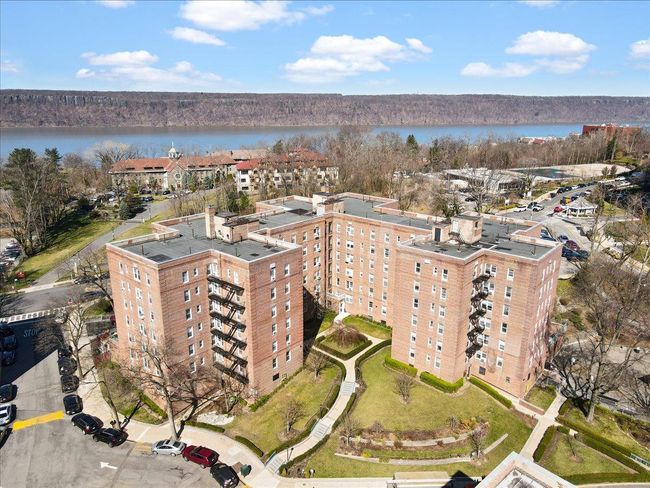 Aerial overview of property's location featuring a nearby body of water and apartment complex | Image 7