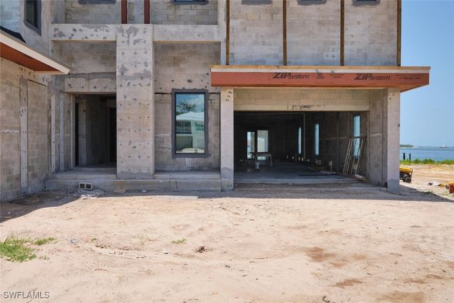Doorway to property featuring a water view and stone siding | Image 4